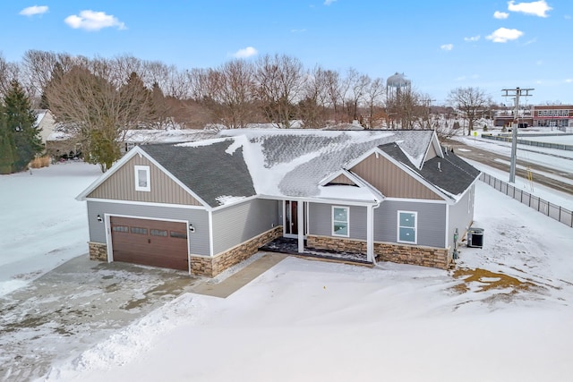 craftsman house with central air condition unit and a garage