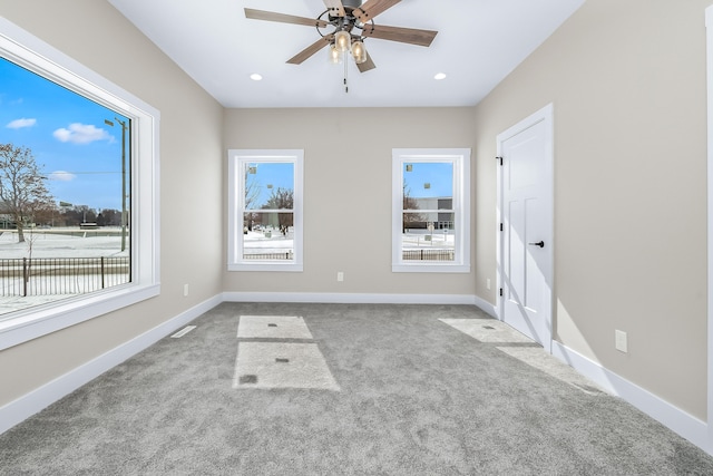 empty room featuring ceiling fan and light colored carpet