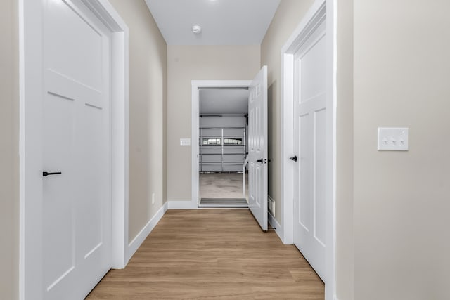 corridor featuring light hardwood / wood-style floors