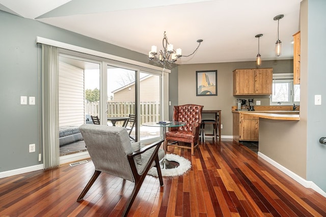 dining area with a chandelier, dark wood finished floors, visible vents, and baseboards