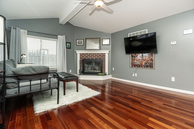 living room with a fireplace, lofted ceiling with beams, baseboards, and wood finished floors