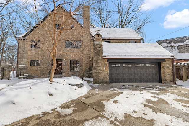 view of front of property featuring a garage and stone siding