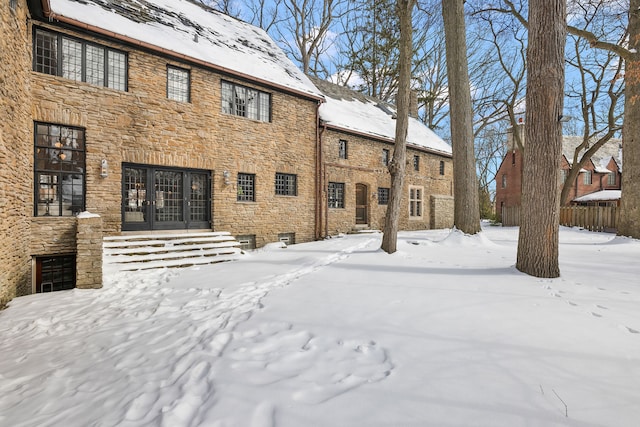 view of snow covered rear of property