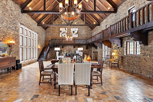 dining room with wooden ceiling, an inviting chandelier, and a high ceiling