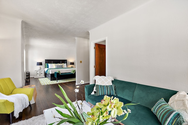 interior space with dark wood-style floors, baseboards, and a textured ceiling