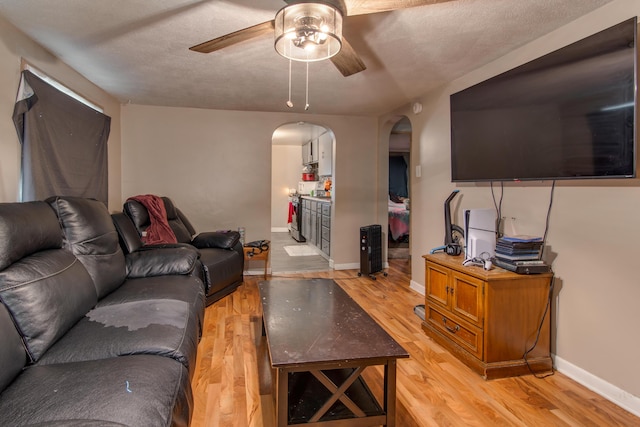 living room featuring ceiling fan and light hardwood / wood-style flooring