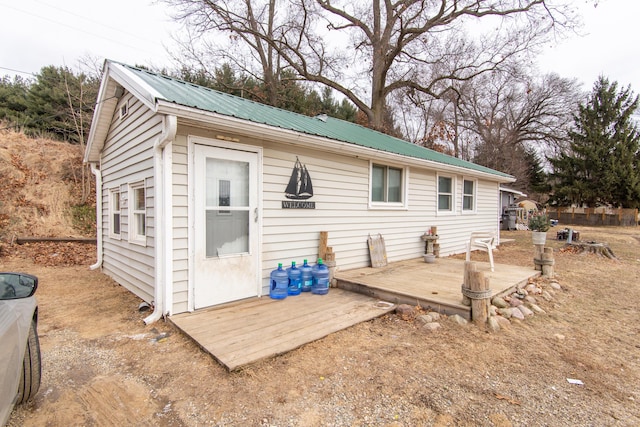 back of house featuring a wooden deck