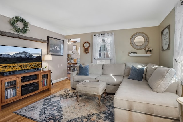 living room with hardwood / wood-style flooring and ceiling fan