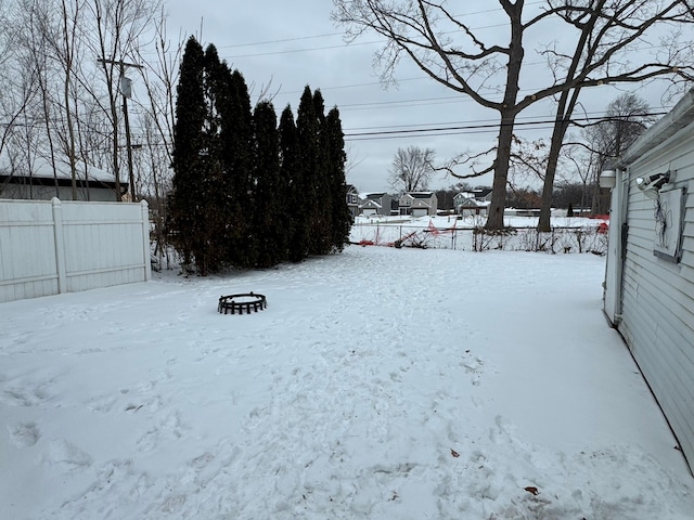 yard covered in snow featuring a fire pit