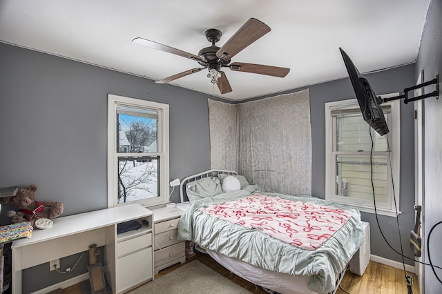 bedroom featuring light wood-type flooring and ceiling fan