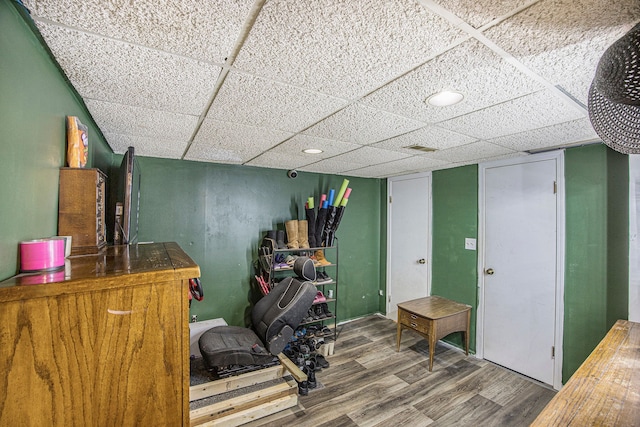 office with hardwood / wood-style floors and a drop ceiling