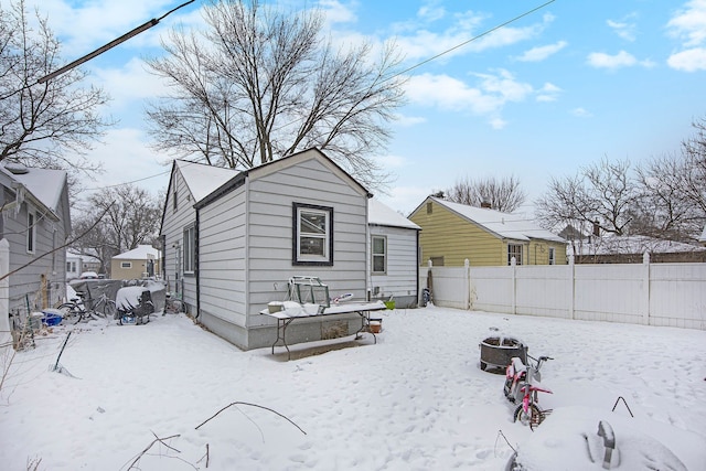 snow covered house with a fire pit