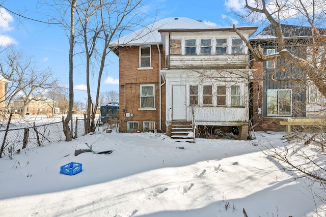 view of snow covered rear of property