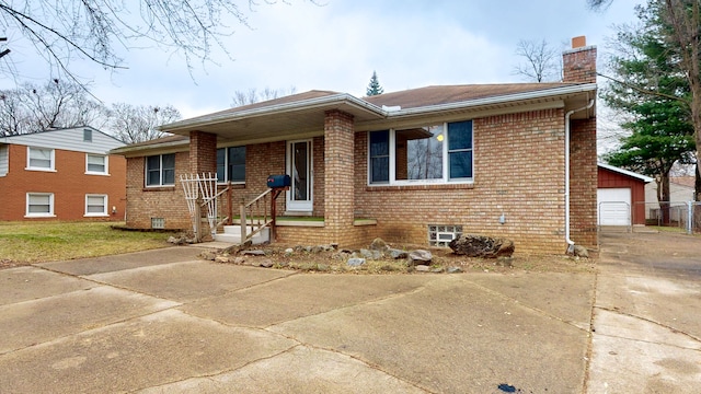 view of front of house with a garage and an outbuilding