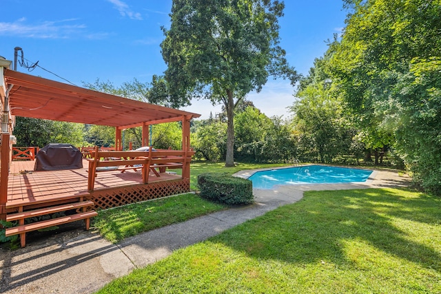 outdoor pool featuring a yard, area for grilling, and a wooden deck