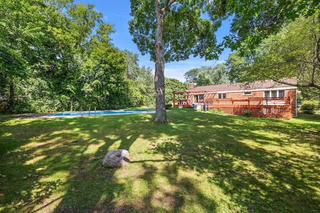 view of yard with an outdoor pool and a wooden deck