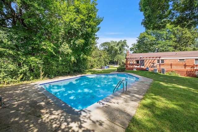 pool featuring a lawn and a deck