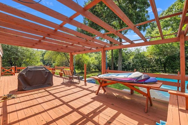 wooden deck with grilling area and a pergola