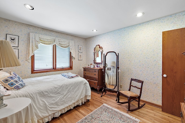 bedroom with baseboards, recessed lighting, light wood-style flooring, and wallpapered walls