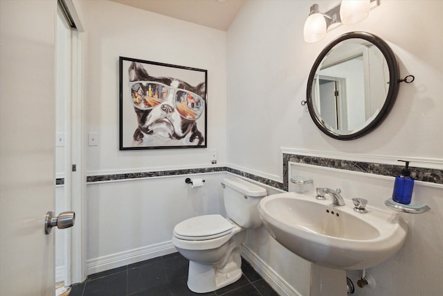 bathroom featuring sink, toilet, and tile patterned floors