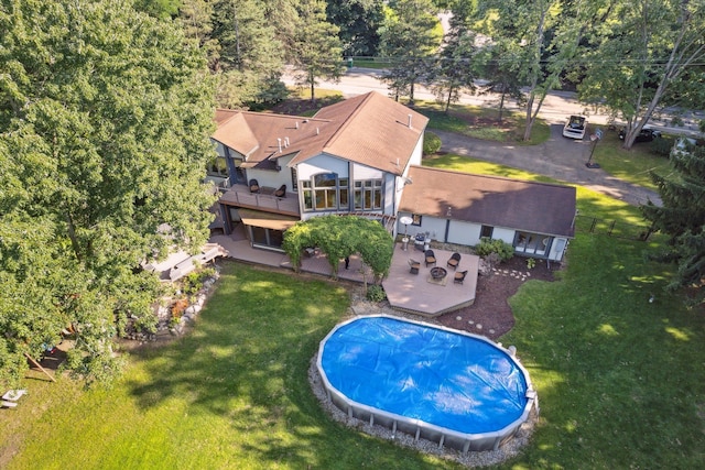 view of pool with a patio and a yard