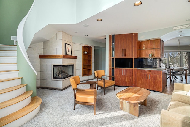 living room featuring a tile fireplace