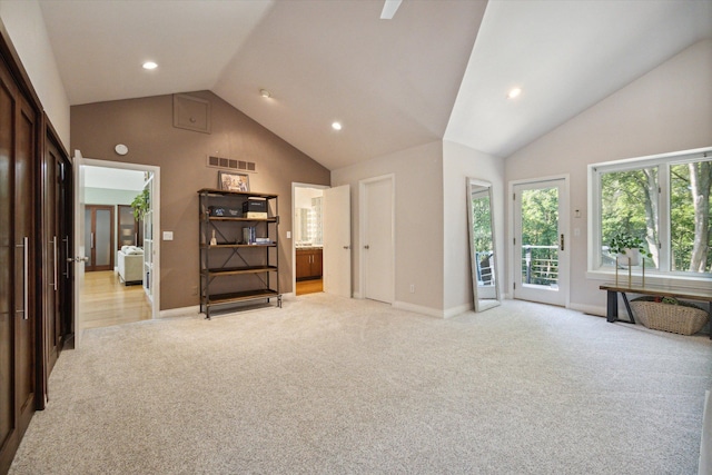 interior space featuring ensuite bathroom, high vaulted ceiling, and access to outside