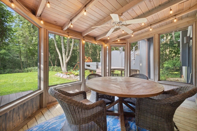 sunroom featuring ceiling fan, beamed ceiling, rail lighting, and wood ceiling