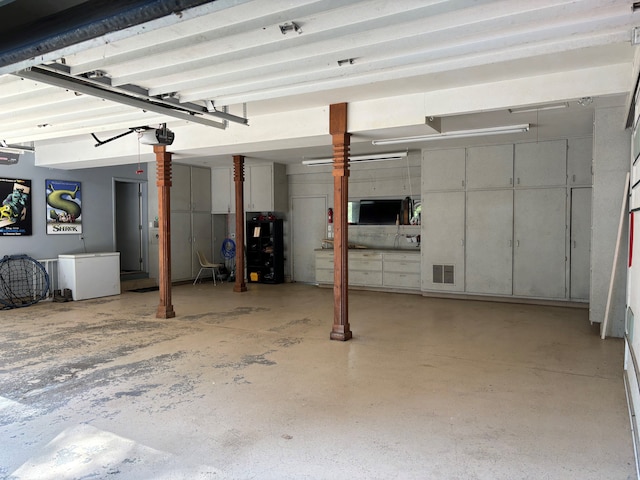 garage featuring refrigerator and a garage door opener