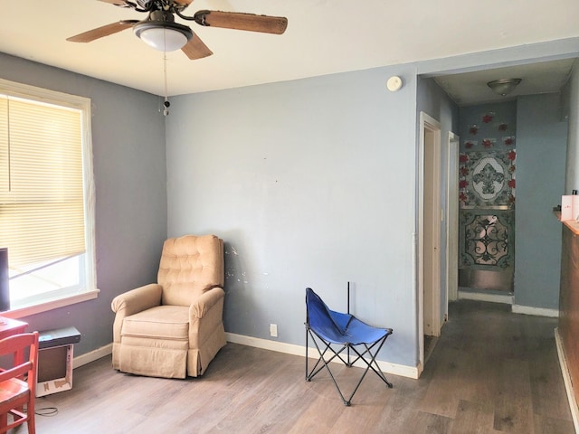 sitting room featuring hardwood / wood-style floors and ceiling fan