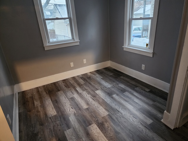 spare room featuring dark hardwood / wood-style flooring