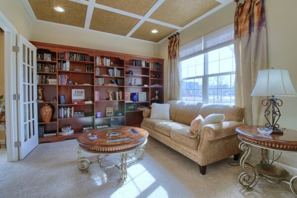 sitting room with ornamental molding, carpet, coffered ceiling, and recessed lighting