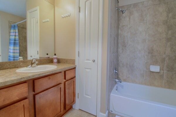 full bathroom with shower / bath combo with shower curtain and vanity