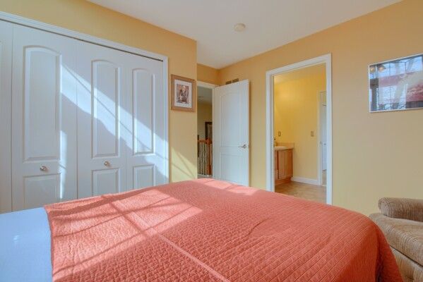 bedroom with ensuite bath and a closet