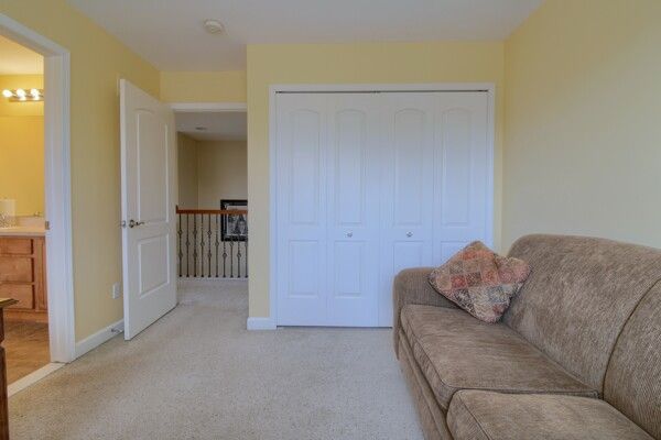 sitting room featuring light carpet and baseboards