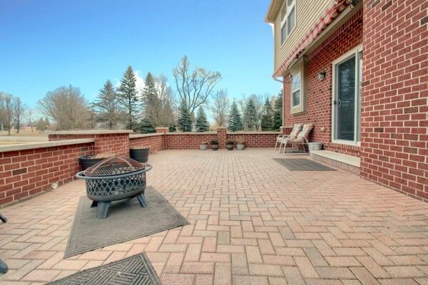 9077 Chambord Dr, Ypsilanti, MI 48197 - view of patio featuring a fire pit