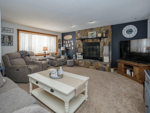 carpeted living room with a stone fireplace