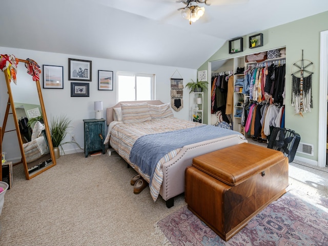 carpeted bedroom featuring a closet, vaulted ceiling, and ceiling fan