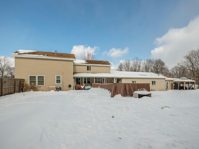 view of snow covered back of property