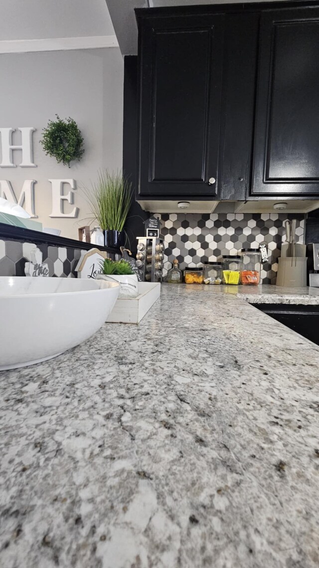 room details featuring sink, crown molding, and tasteful backsplash