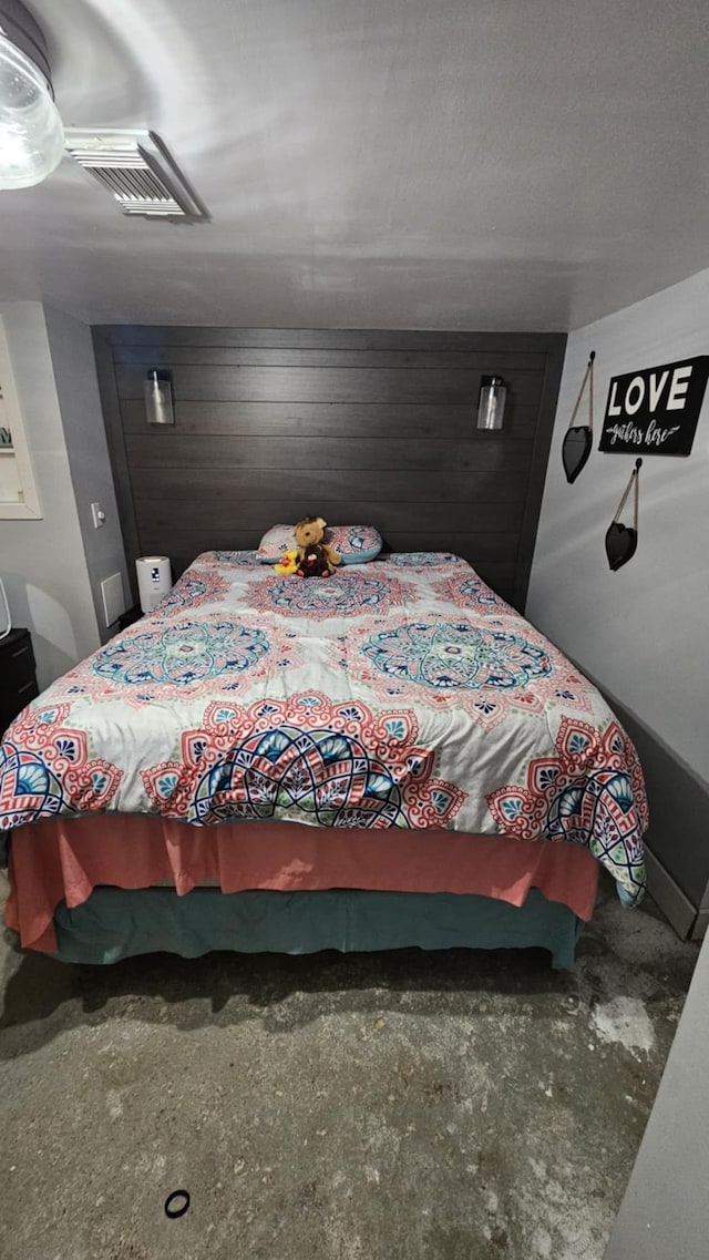 bedroom with wood walls