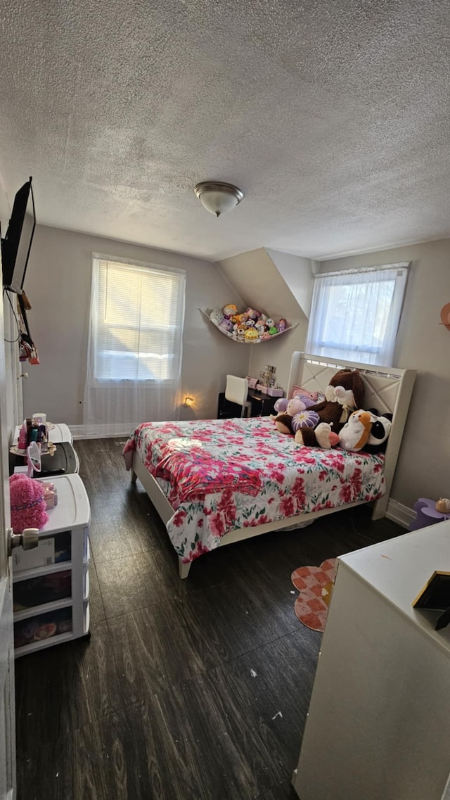 bedroom featuring a textured ceiling, dark hardwood / wood-style floors, and lofted ceiling