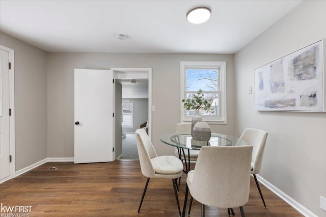 dining area with dark hardwood / wood-style flooring