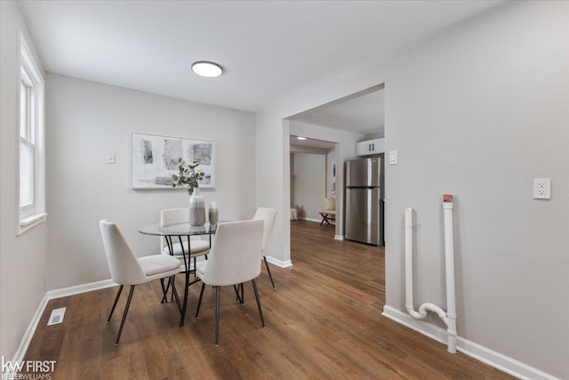 dining space with dark wood-type flooring