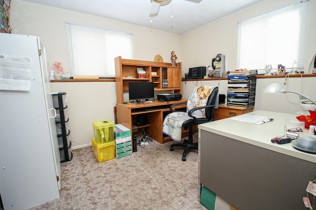 office featuring ceiling fan and light colored carpet