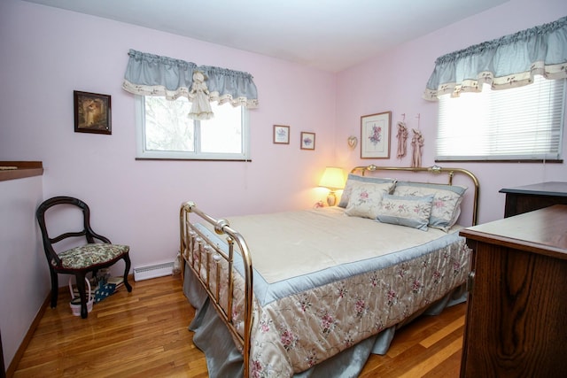 bedroom featuring hardwood / wood-style flooring and a baseboard radiator