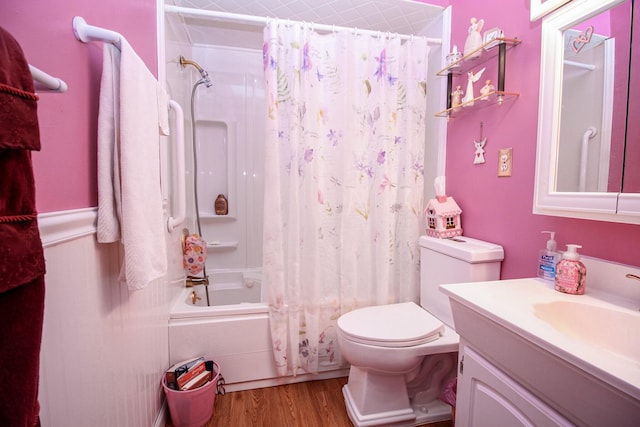 full bathroom with shower / bath combo with shower curtain, vanity, hardwood / wood-style floors, and toilet