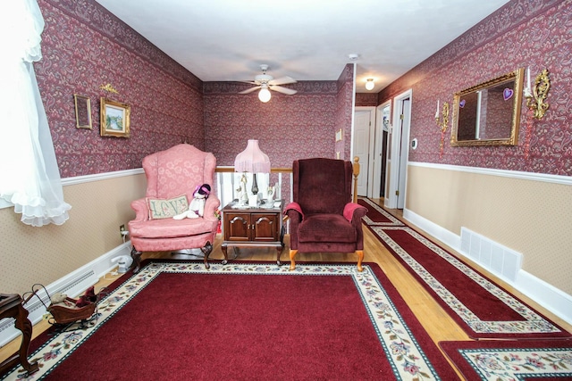 living area with ceiling fan and wood-type flooring