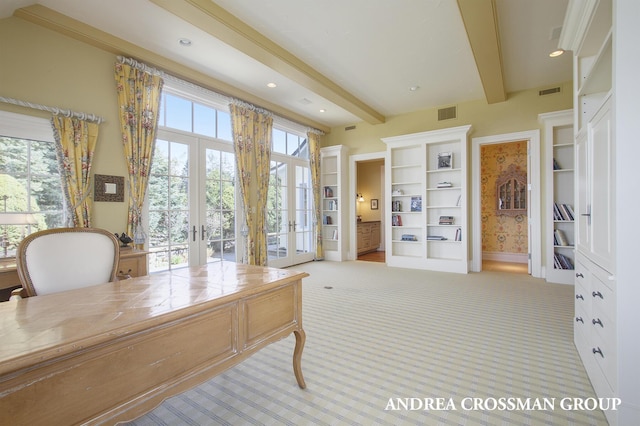 carpeted office with french doors and beamed ceiling