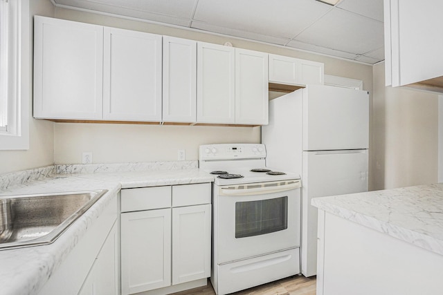 kitchen with white cabinetry, light wood-type flooring, sink, white appliances, and a drop ceiling